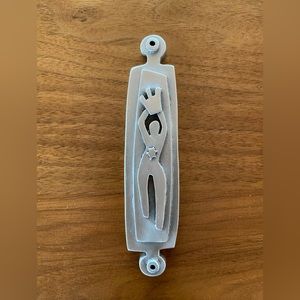 Pewter figure mezuzah case by Emily Rosenfeld.